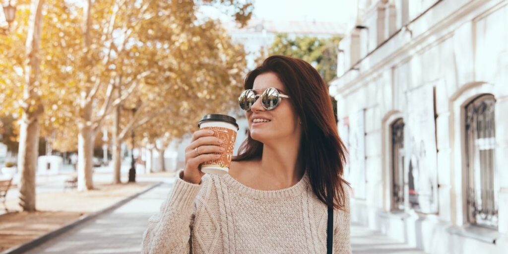 woman drinking coffee on the street